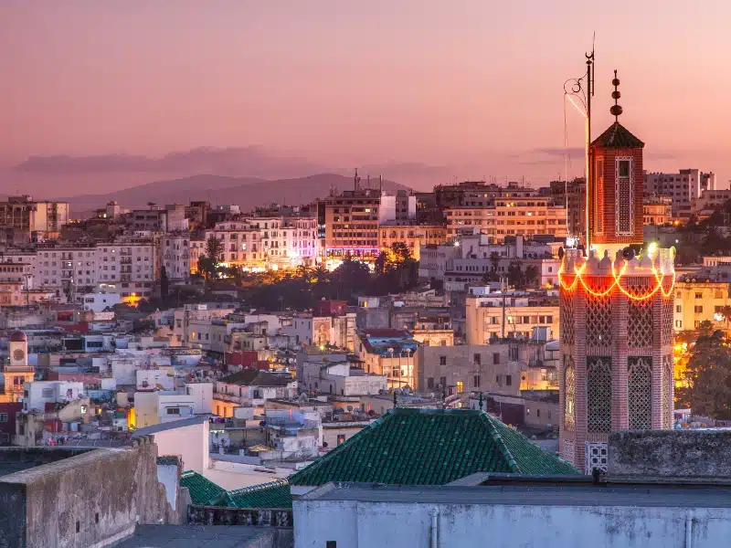 The post city of Tangier at night with the minaret of the Kasbah Mosque in the foreground