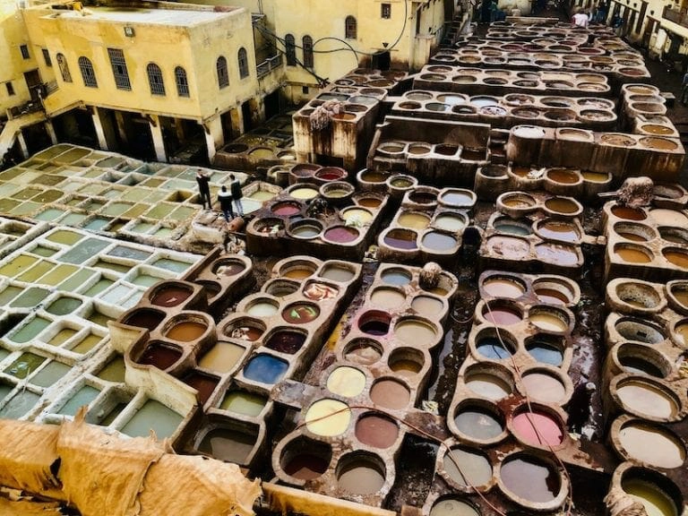 vats of colourful leather dye in a traditional Moroccan tannery