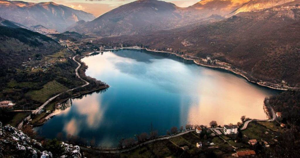 Heart shaped lake surrounded by mountains at dusk